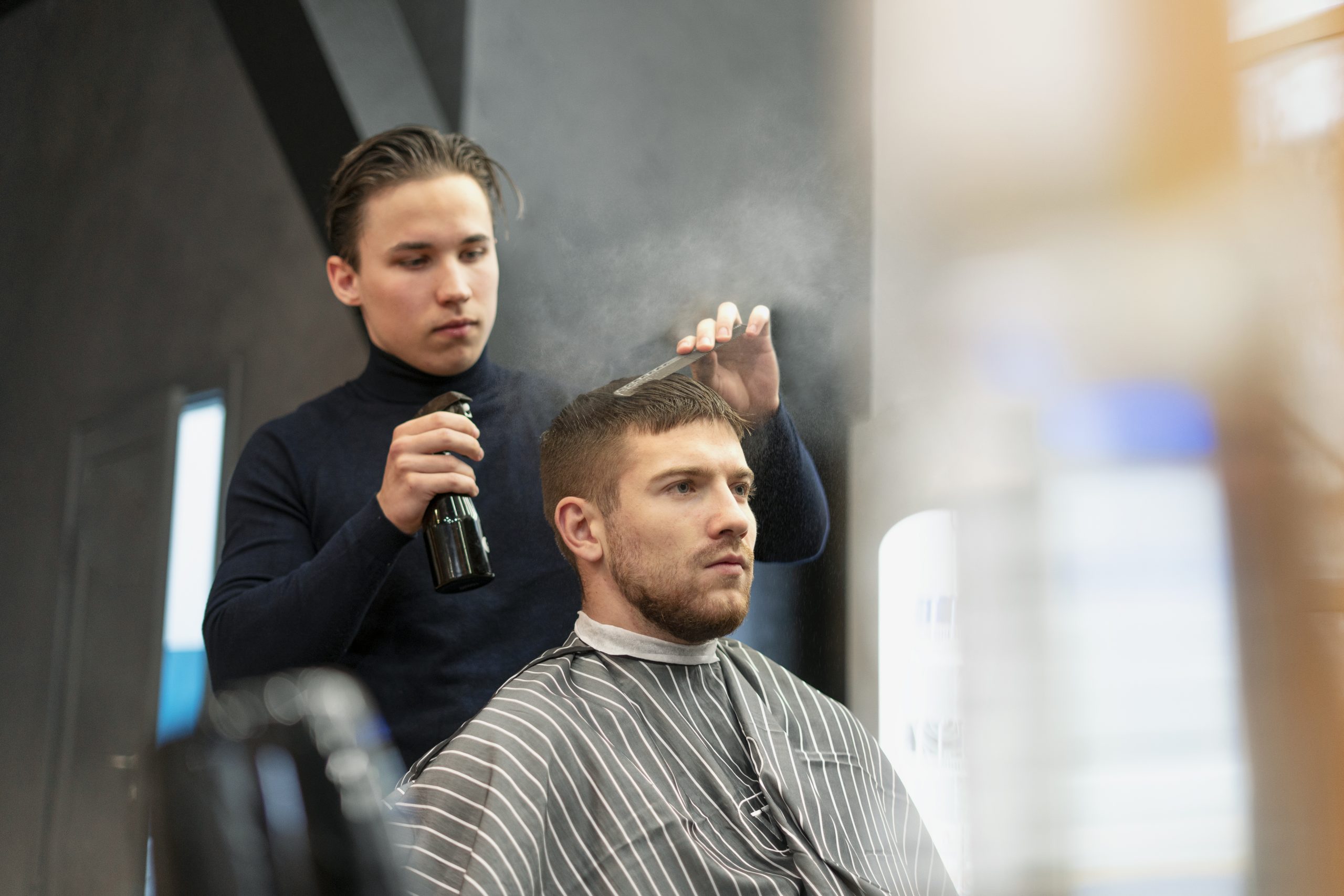 medium-shot-young-man-getting-haircut